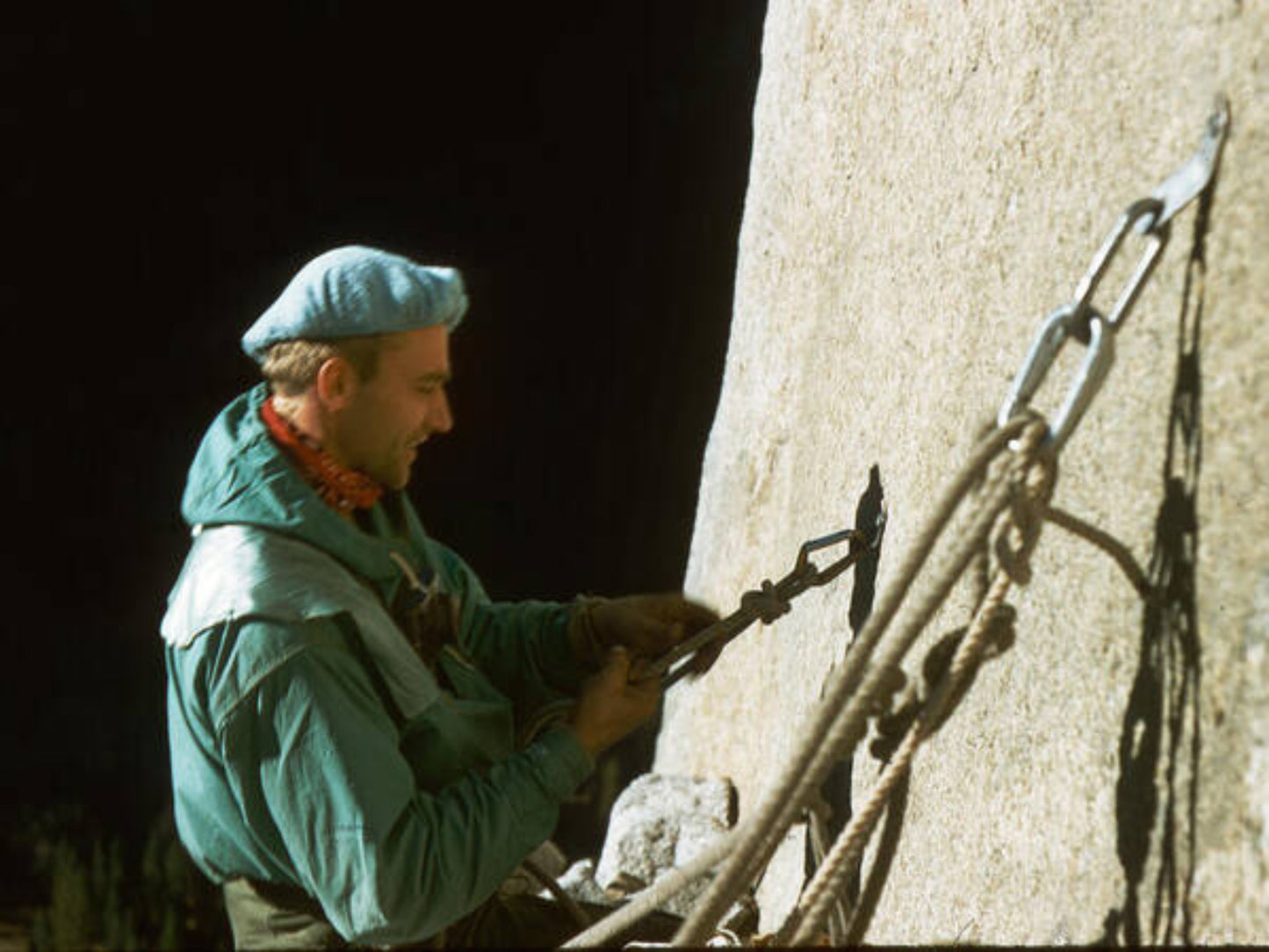 A photo print featuring a person climbing a mountain, wearing a cap and a green jacket, with a visible climbing route and gear.