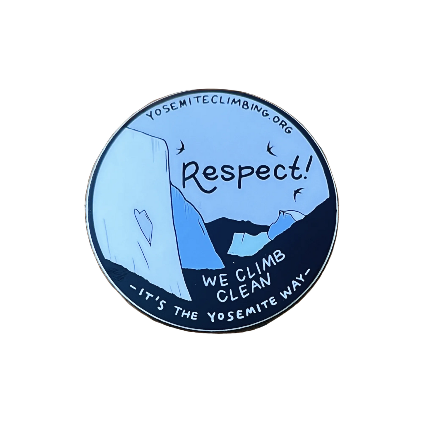 A round sticker with a blue and white color scheme featuring text and graphics related to Yosemite Climbing Association's values, placed on a wooden surface.