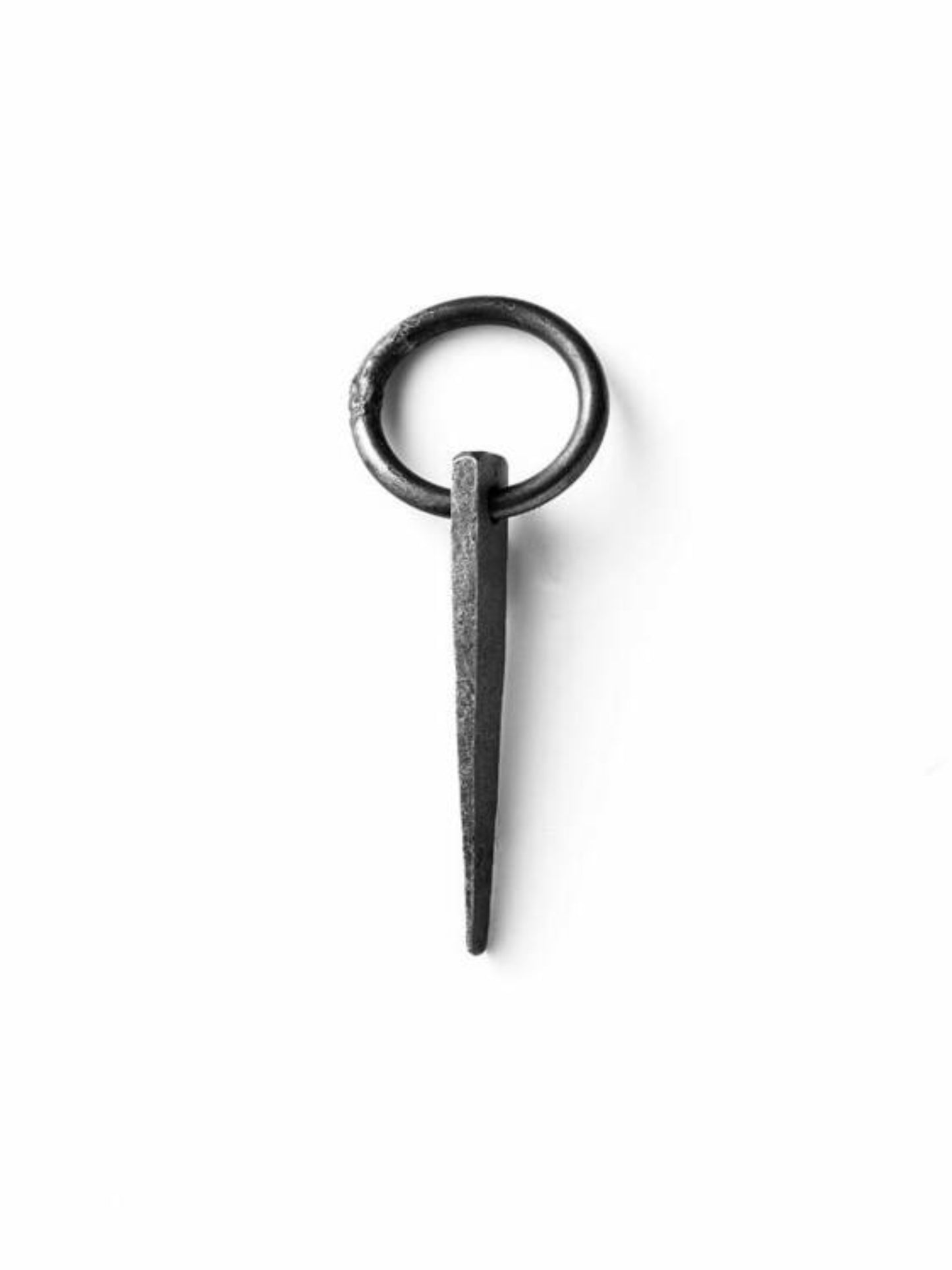 A black and white photo print of a hand-made ring spike piton by Jerry Gallwas.