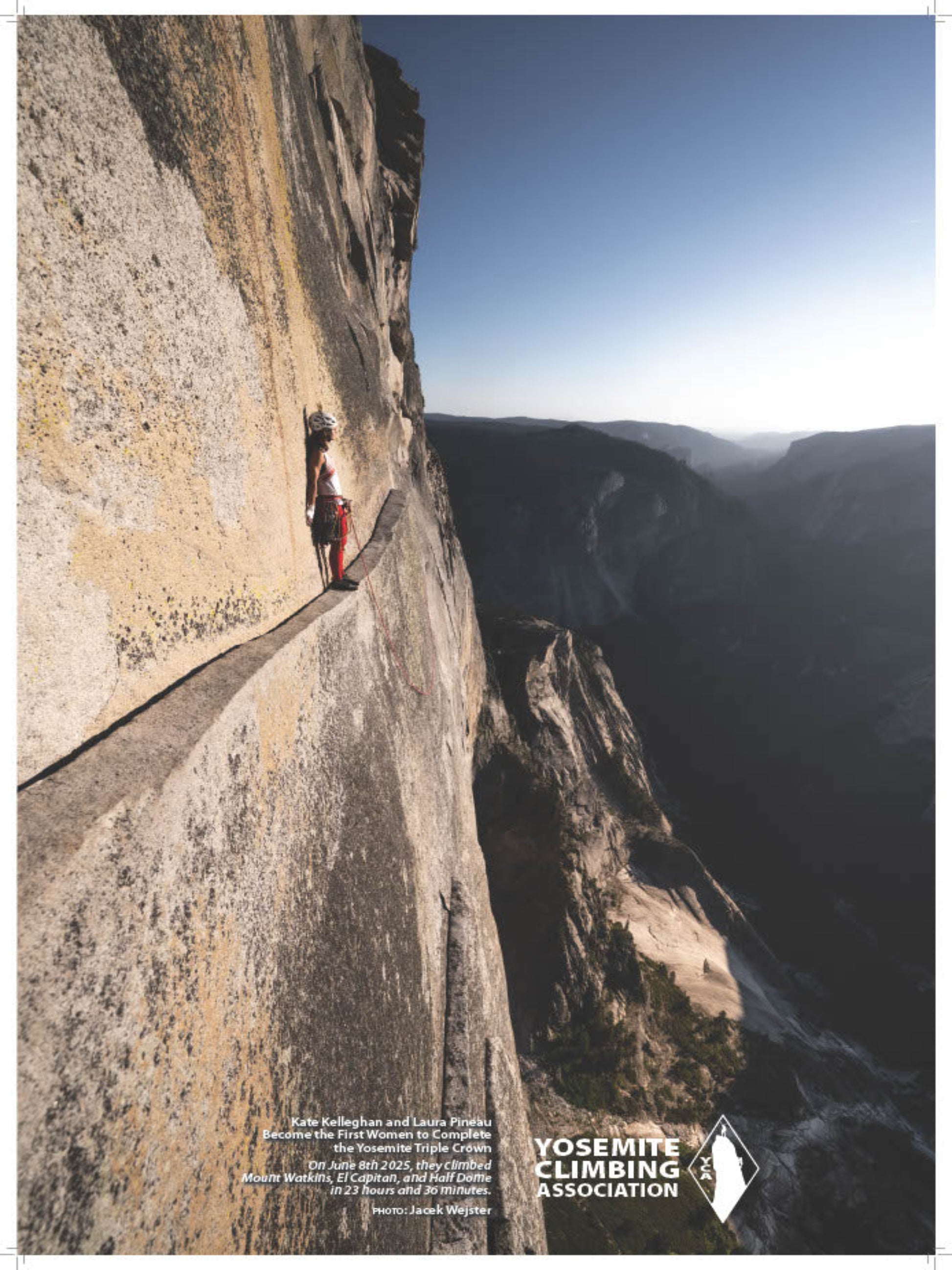 Person climbing a steep cliff face with a scenic view of a valley.