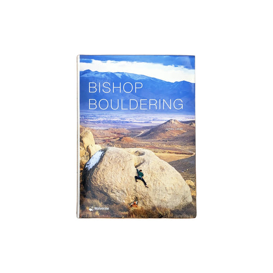 Book titled 'Bishop Bouldering' on a wooden surface